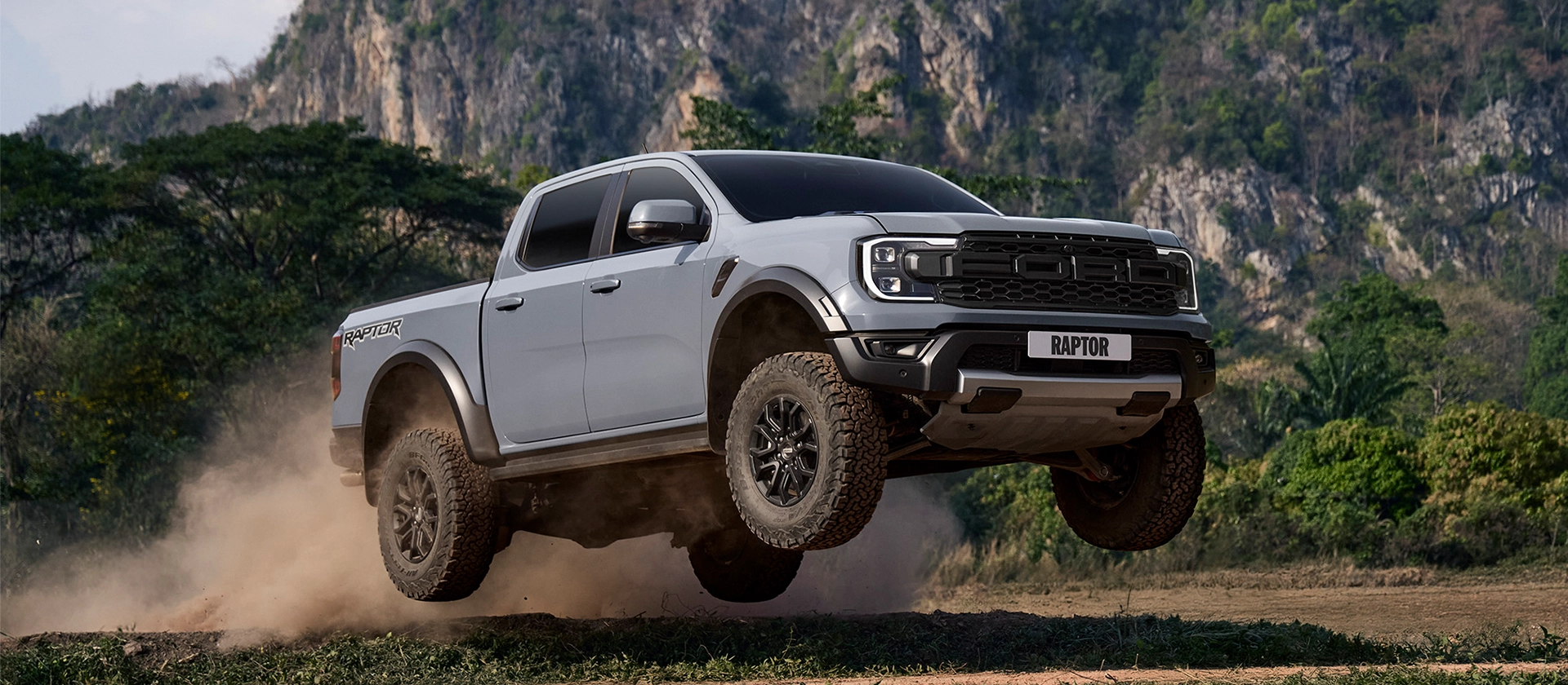 ford raptor fornt side offroading in the hills on model-raptor