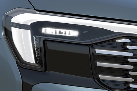 front zoom view of headlight of grey car